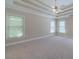 Large bedroom with neutral carpet, tray ceiling, and plenty of natural light at 776 Myerston Ct, Lawrenceville, GA 30044