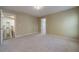 Neutral bedroom with large windows, plush carpet, and open doorway to hall at 776 Myerston Ct, Lawrenceville, GA 30044
