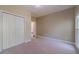 Bedroom with neutral carpet, white trim, and a double-door closet at 776 Myerston Ct, Lawrenceville, GA 30044