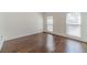 Simple bedroom with hardwood floors, two windows with blinds, and neutral wall color at 776 Myerston Ct, Lawrenceville, GA 30044