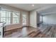 Eat-in kitchen area with stainless steel appliances, white cabinets, tile backsplash, wood floors, and natural light at 776 Myerston Ct, Lawrenceville, GA 30044
