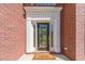 Elegant brick home with a front door featuring decorative glass and white trim, plus a welcome mat at 776 Myerston Ct, Lawrenceville, GA 30044