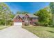Classic brick home featuring manicured lawn, mature trees, and attached two car garage at 776 Myerston Ct, Lawrenceville, GA 30044