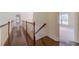 Upstairs hallway with hardwood flooring and views into other rooms at 776 Myerston Ct, Lawrenceville, GA 30044