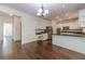 Bright kitchen with white cabinets, stainless steel appliances, and a granite countertop island for seating at 776 Myerston Ct, Lawrenceville, GA 30044
