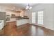 Bright kitchen with white cabinets, stainless steel appliances, and a breakfast bar overlooking the deck at 776 Myerston Ct, Lawrenceville, GA 30044