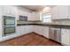 Close-up of the kitchen with stainless steel appliances, and white cabinets for storage at 776 Myerston Ct, Lawrenceville, GA 30044