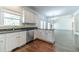 Bright kitchen with white cabinets, stainless steel appliances, and a large sink with a view of the backyard at 776 Myerston Ct, Lawrenceville, GA 30044