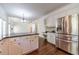 Bright kitchen features an island, stainless steel refrigerator and white cabinets at 776 Myerston Ct, Lawrenceville, GA 30044