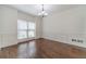 Bright living room featuring hardwood floors, decorative trim, wainscotting and a large window at 776 Myerston Ct, Lawrenceville, GA 30044