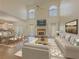Spacious living room featuring a fireplace, vaulted ceiling, and an open-concept layout with dining area at 776 Myerston Ct, Lawrenceville, GA 30044