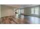 Open living room features wood flooring, two large windows, and neutral paint for a serene space at 776 Myerston Ct, Lawrenceville, GA 30044