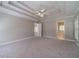 A spacious main bedroom with a coffered ceiling and a ceiling fan light fixture at 776 Myerston Ct, Lawrenceville, GA 30044