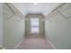 Walk-in closet with carpeted floor, shelving and natural light at 776 Myerston Ct, Lawrenceville, GA 30044