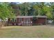 A view of the back exterior showing the home's brick facade and backyard at 2081 Beecher Sw Rd, Atlanta, GA 30311