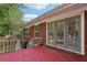 Back patio with brick home has French doors, greenery, and a cozy atmosphere at 2081 Beecher Sw Rd, Atlanta, GA 30311