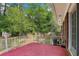 Back patio with trees, white iron fence, and greenery creates a welcoming outdoor space at 2081 Beecher Sw Rd, Atlanta, GA 30311