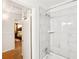 Renovated bathroom features sleek tile shower, with a doorway leading to a bedroom at 2081 Beecher Sw Rd, Atlanta, GA 30311