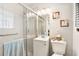Cozy bathroom features a glass shower, white vanity, and religious art at 2081 Beecher Sw Rd, Atlanta, GA 30311