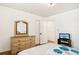 Well-lit bedroom features wood floors and a classic dresser, offering a cozy atmosphere at 2081 Beecher Sw Rd, Atlanta, GA 30311