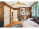 Bedroom with wood paneling, classic ceiling fan, and eclectic decor at 2081 Beecher Sw Rd, Atlanta, GA 30311