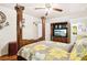 Primary bedroom features a four-poster bed, hardwood floors, tv, and ceiling fan at 2081 Beecher Sw Rd, Atlanta, GA 30311