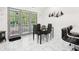 Dining area with a glass table, seating for four, tile floors and glass doors to the patio at 2081 Beecher Sw Rd, Atlanta, GA 30311