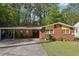 Charming brick home featuring a covered carport and a well-manicured lawn at 2081 Beecher Sw Rd, Atlanta, GA 30311