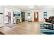 Spacious living room with wood-look flooring, built-in shelves, and a large window at 2081 Beecher Sw Rd, Atlanta, GA 30311