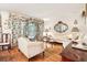 Cozy living room with hardwood floors, floral drapes, a decorative mirror, and comfortable seating at 2081 Beecher Sw Rd, Atlanta, GA 30311