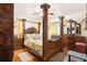 Elegant main bedroom with a large four-poster bed and stylish furnishings at 2081 Beecher Sw Rd, Atlanta, GA 30311