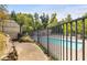 Community pool area enclosed by a black metal fence, offering a refreshing retreat at 284 Lakemoore Ne Dr # E, Atlanta, GA 30342