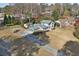 Aerial view of a gray home with expansive lawn, mature trees, and long driveway on a sunny day at 4036 Winding Valley Se Dr, Smyrna, GA 30082