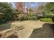 A well-maintained lawn with decorative garden beds showcases the beauty of the backyard at 4036 Winding Valley Se Dr, Smyrna, GA 30082