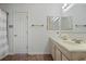 Bathroom featuring a double sink vanity, linen cabinet, and a shower curtain at 4036 Winding Valley Se Dr, Smyrna, GA 30082