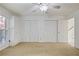 Bright bedroom featuring neutral carpet, ample closet space, and a ceiling fan with light fixture at 4036 Winding Valley Se Dr, Smyrna, GA 30082