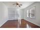 Bright bedroom featuring hardwood flooring, two windows, and a ceiling fan at 4036 Winding Valley Se Dr, Smyrna, GA 30082
