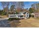 Charming two-story home with stone accents, manicured lawn, and mature trees on a sunny day at 4036 Winding Valley Se Dr, Smyrna, GA 30082
