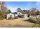 Exterior view of the home with outbuilding, backyard, and fenced-in area at 4036 Winding Valley Se Dr, Smyrna, GA 30082