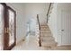 Inviting foyer with travertine flooring, stained glass entry, and a staircase at 4036 Winding Valley Se Dr, Smyrna, GA 30082