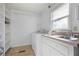 Bright laundry room featuring a washer, dryer, and ample shelving space for organization at 4036 Winding Valley Se Dr, Smyrna, GA 30082
