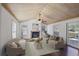 Bright living room with vaulted ceilings, a fireplace, and an access door to the patio at 4036 Winding Valley Se Dr, Smyrna, GA 30082