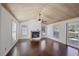 Cozy living room featuring hardwood floors, a brick fireplace, a vaulted ceiling, and natural light at 4036 Winding Valley Se Dr, Smyrna, GA 30082
