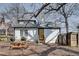 Backyard of white house with a picnic table, privacy fence, mature trees, and a lawn at 934 Hope Dr, Atlanta, GA 30310