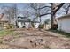View of backyard with mature trees, picnic table, fire pit, a white home with a dark trim, and privacy fence at 934 Hope Dr, Atlanta, GA 30310