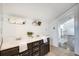Bathroom features a double sink vanity, tiled floor, mirrors, and an open doorway leading to a bright hallway at 934 Hope Dr, Atlanta, GA 30310