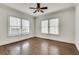 Bright bedroom featuring two large windows, hardwood floors, and a ceiling fan at 934 Hope Dr, Atlanta, GA 30310