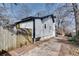 Exterior side view of renovated bungalow featuring a driveway and back entrance at 934 Hope Dr, Atlanta, GA 30310