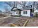 Renovated bungalow featuring black trim, white siding and a small garden at 934 Hope Dr, Atlanta, GA 30310