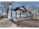 Side view of renovated bungalow featuring a chimney and white picket fence at 934 Hope Dr, Atlanta, GA 30310
